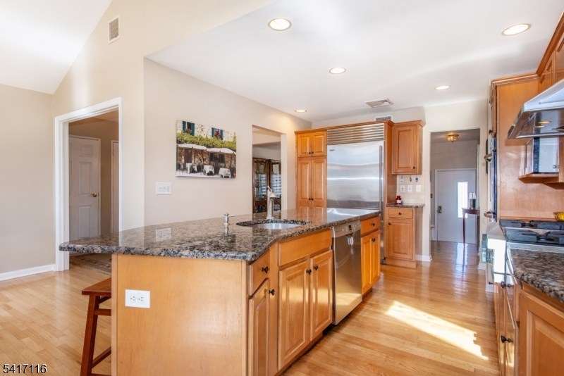 29 Long Acres Road Fairfield, NJ 07004 - Photo 15 of 33 a bathroom with stainless steel appliances granite countertop a sink and a refrigerator