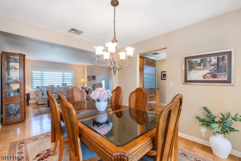29 Long Acres Road Fairfield, NJ 07004 - Photo 18 of 33 a dining room with furniture a chandelier and window