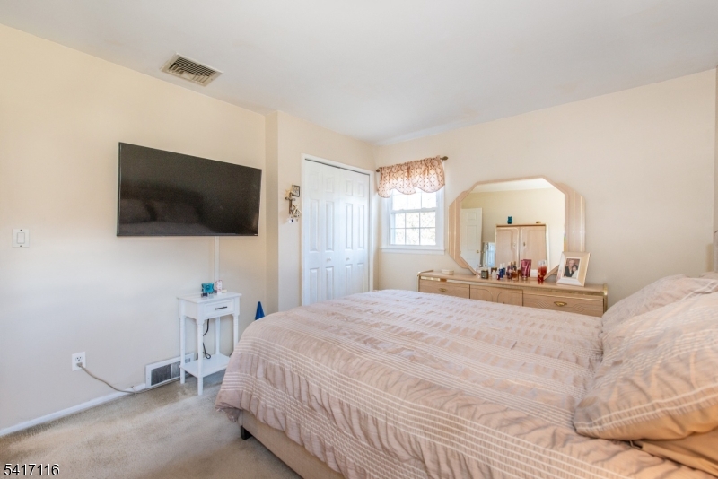 29 Long Acres Road Fairfield, NJ 07004 - Photo 21 of 33 a bedroom with a bed and a flat screen tv