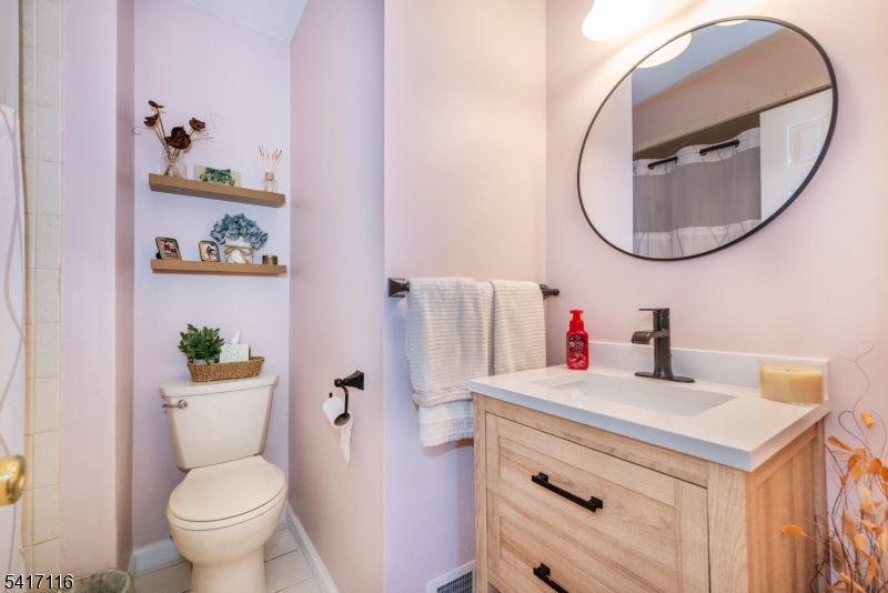 29 Long Acres Road Fairfield, NJ 07004 - Photo 26 of 33 a bathroom with a sink mirror and toilet