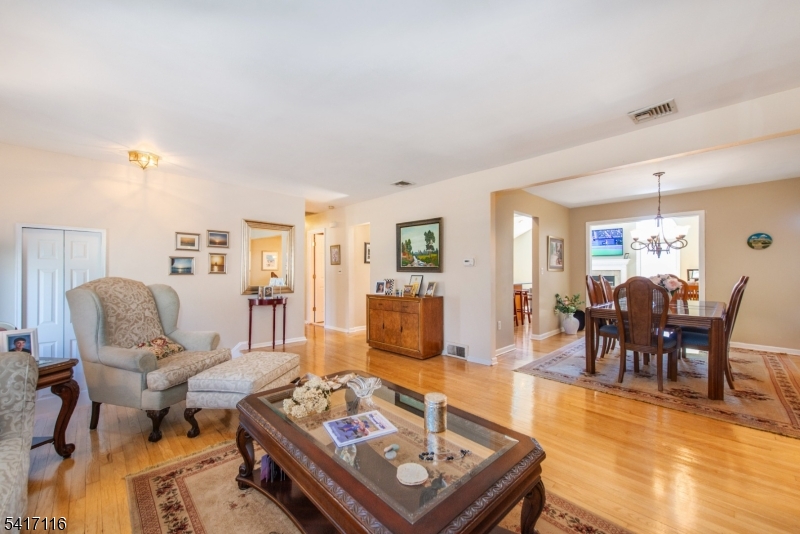 29 Long Acres Road Fairfield, NJ 07004 - Photo 3 of 33 a living room with furniture and wooden floor