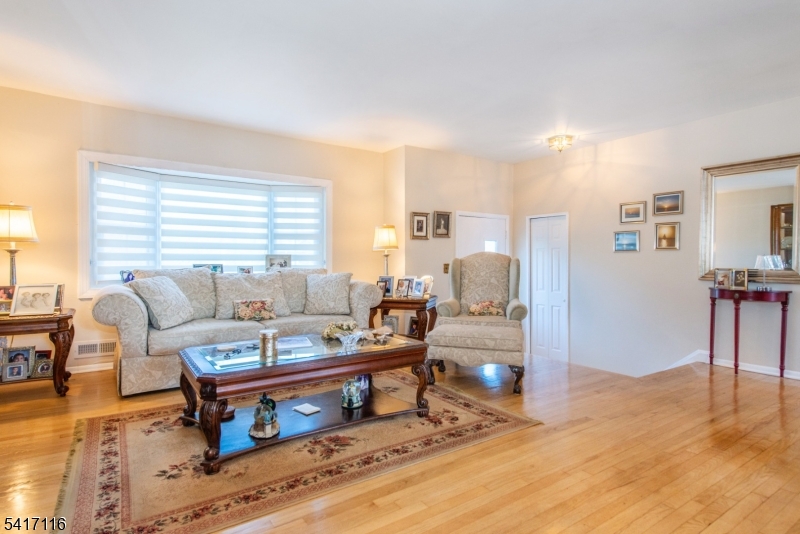 29 Long Acres Road Fairfield, NJ 07004 - Photo 4 of 33 a living room with furniture and a wooden floor