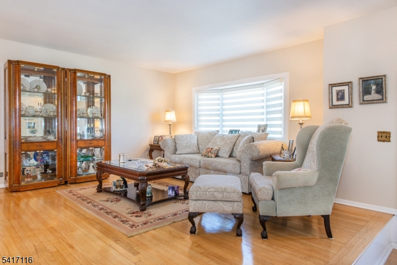 29 Long Acres Road Fairfield, NJ 07004 - Photo 5 of 33 a living room with furniture and wooden floor