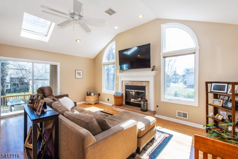 29 Long Acres Road Fairfield, NJ 07004 - Photo 7 of 33 a bedroom with a large bed and a flat screen tv