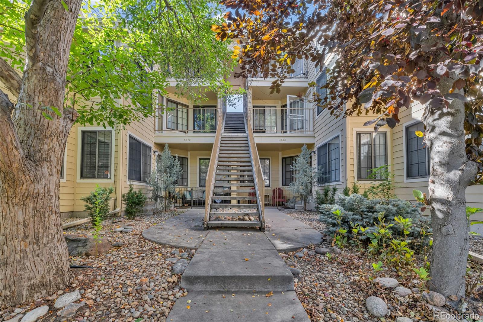 4840 East Kentucky Avenue, Unit F Denver, CO 80246 - Photo 1 of 18 a front view of a house with garden