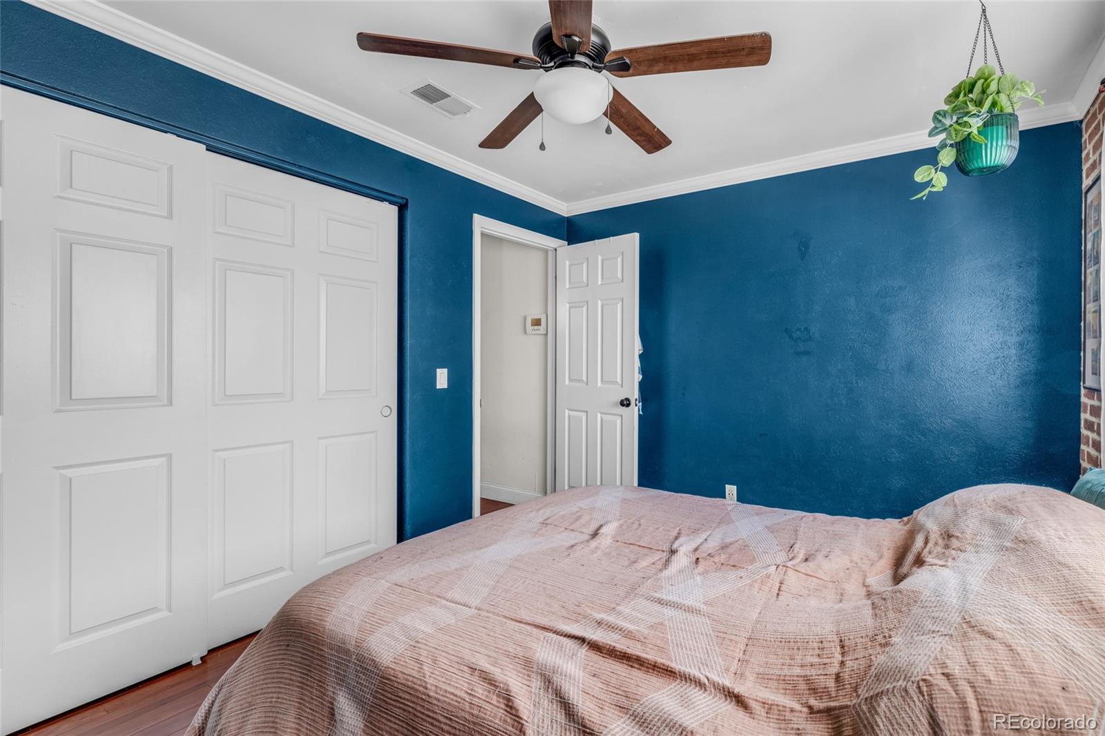 4840 East Kentucky Avenue, Unit F Denver, CO 80246 - Photo 13 of 18 a bedroom with a bed chandelier and a window