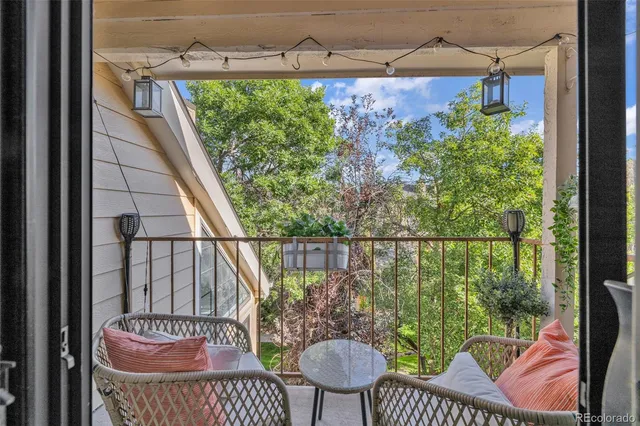 a view of a balcony with chair and table