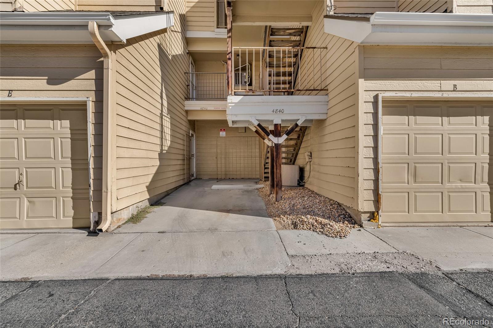 4840 East Kentucky Avenue, Unit F Denver, CO 80246 - Photo 17 of 18 a view of a house with a door and chair