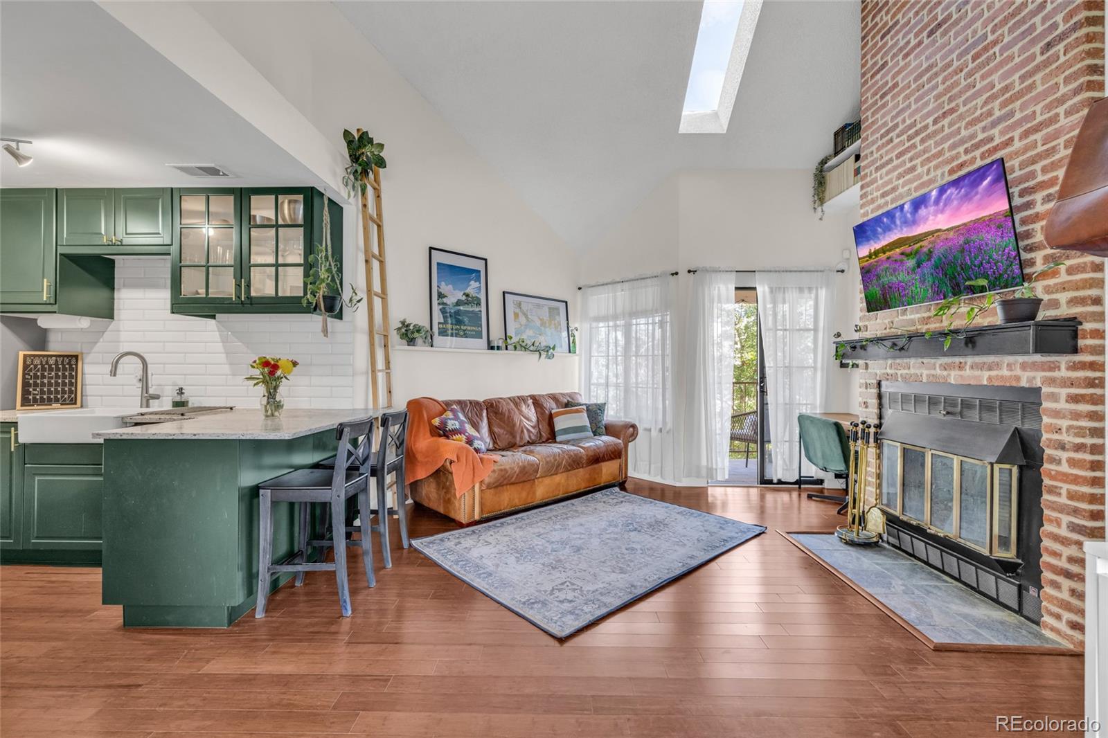 4840 East Kentucky Avenue, Unit F Denver, CO 80246 - Photo 5 of 18 a living room with furniture and a fireplace