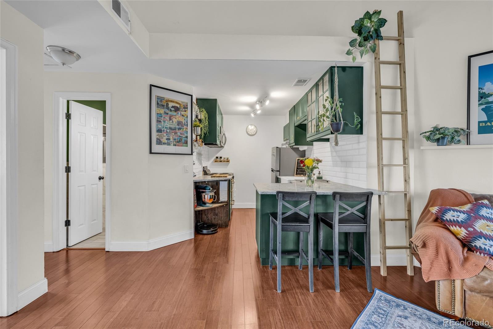 4840 East Kentucky Avenue, Unit F Denver, CO 80246 - Photo 7 of 18 a living room with furniture and wooden floor