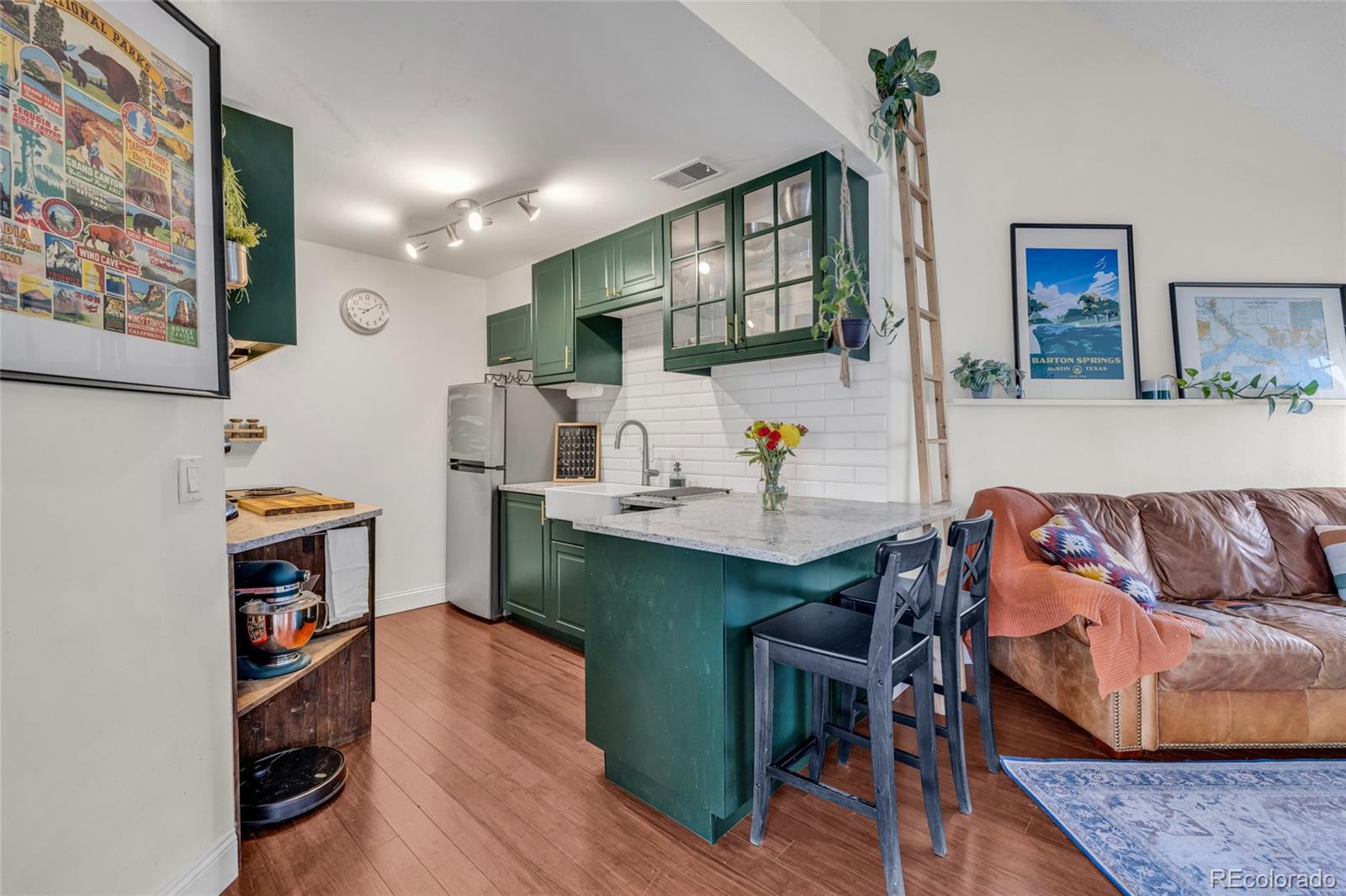 4840 East Kentucky Avenue, Unit F Denver, CO 80246 - Photo 8 of 18 a living room with furniture and a wooden floor
