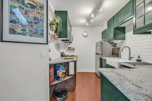 a kitchen with stainless steel appliances granite countertop a sink and a microwave