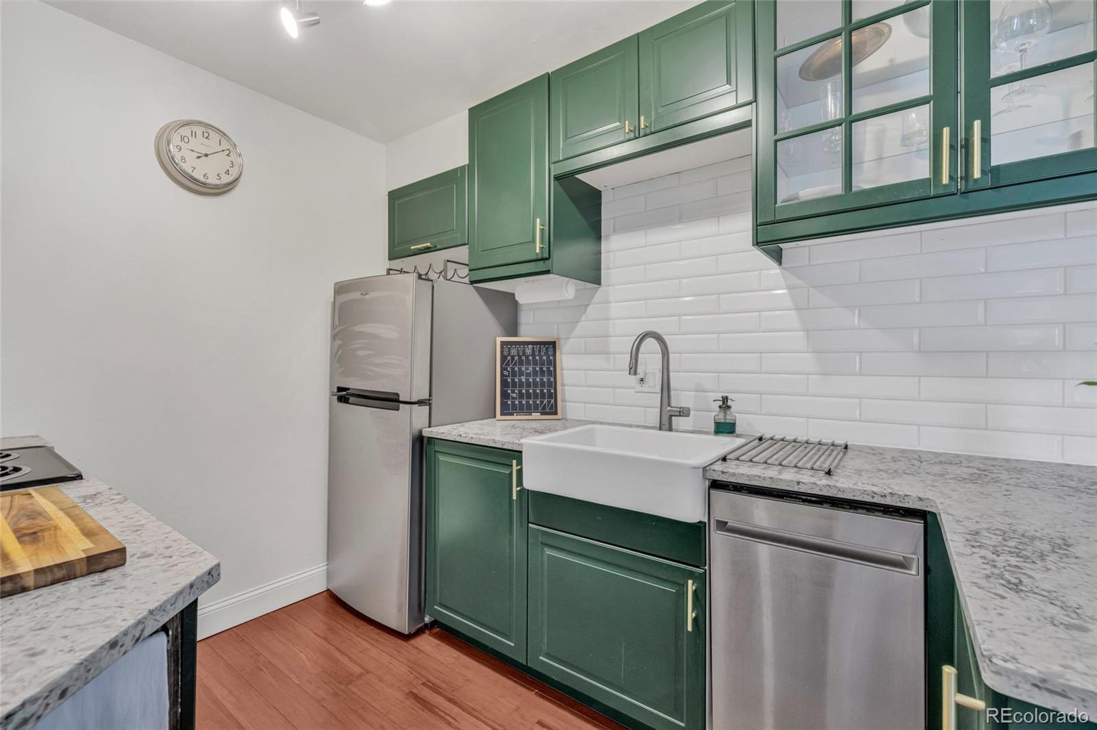 4840 East Kentucky Avenue, Unit F Denver, CO 80246 - Photo 10 of 18 a kitchen with stainless steel appliances granite countertop a sink stove and refrigerator