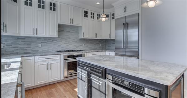 46 Maple Street Needham, MA 02492 - Photo 3 of 12 a kitchen with a sink stove and cabinets