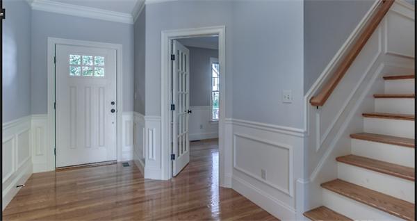 46 Maple Street Needham, MA 02492 - Photo 7 of 12 a view of a hallway with wooden floor and staircase