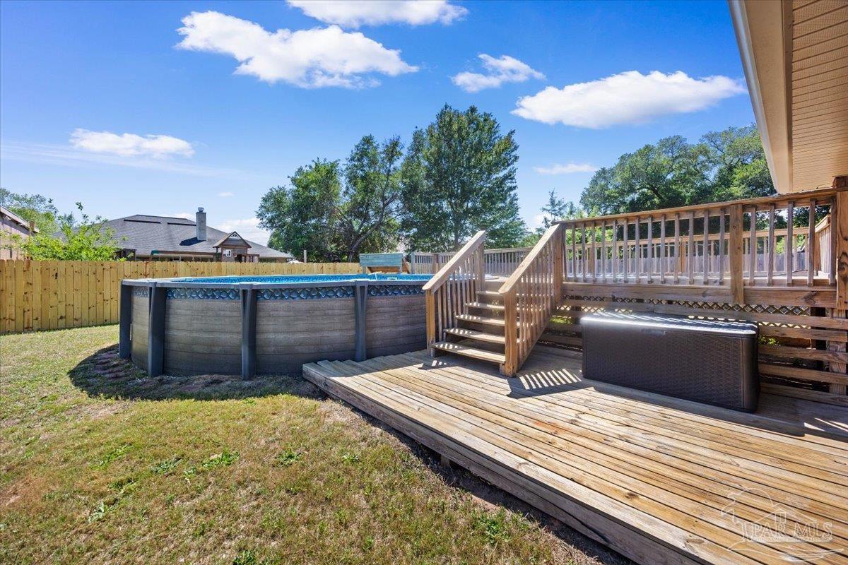 4015 Berry Circle Pace, FL 32571 - Photo 43 of 48 a view of a roof deck with wooden floor and fence