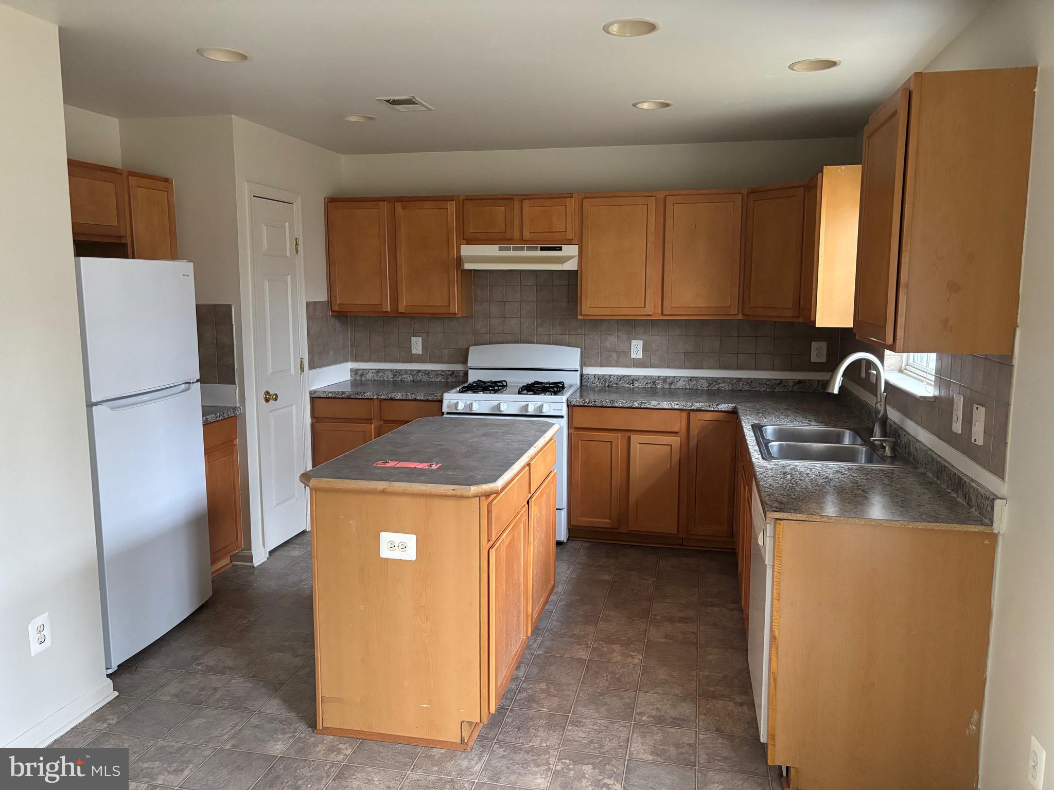 610 Pendleton Lane Strasburg, VA 22657 - Photo 28 of 30 a kitchen with stainless steel appliances granite countertop a stove a sink a refrigerator and a refrigerator