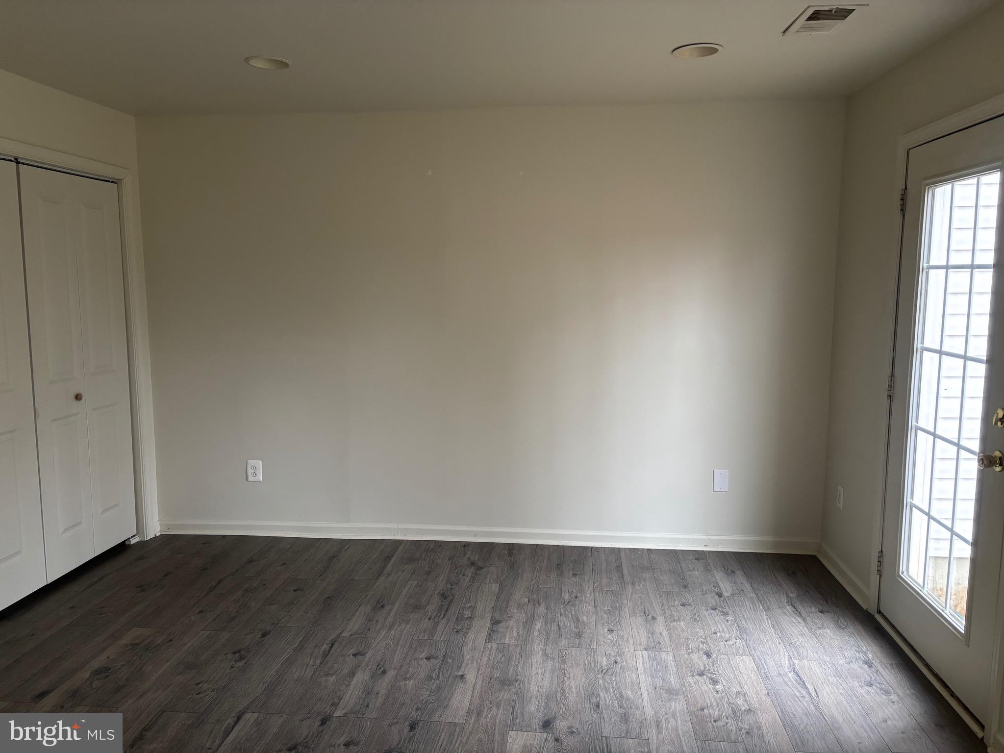610 Pendleton Lane Strasburg, VA 22657 - Photo 6 of 30 an empty room with wooden floor and windows