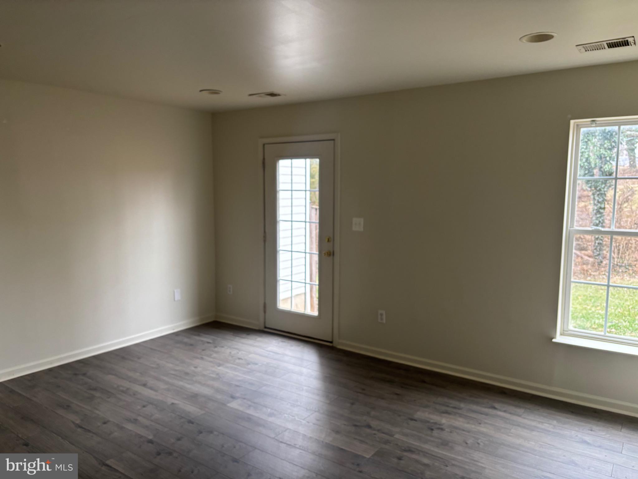 610 Pendleton Lane Strasburg, VA 22657 - Photo 8 of 30 an empty room with wooden floor and windows