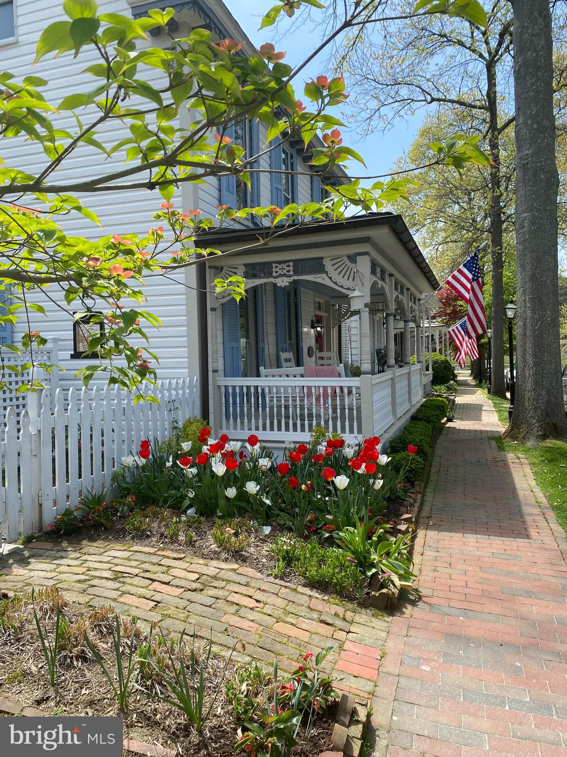 114 West Chestnut Street St. Michaels, MD 21663 - Photo 2 of 75 a view of a house with a yard and flower plants