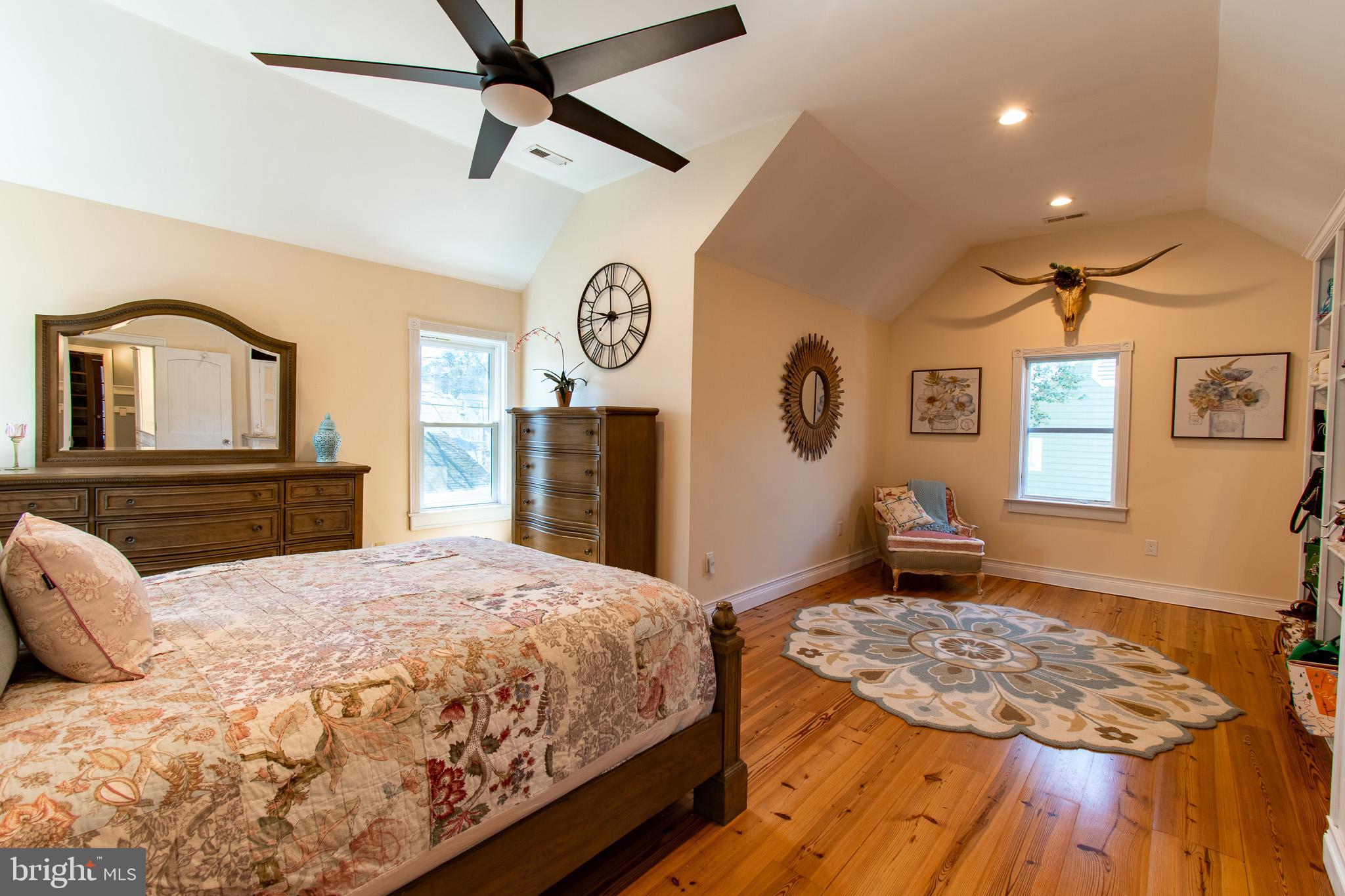 114 West Chestnut Street St. Michaels, MD 21663 - Photo 22 of 75 a bedroom with a bed and a chandelier