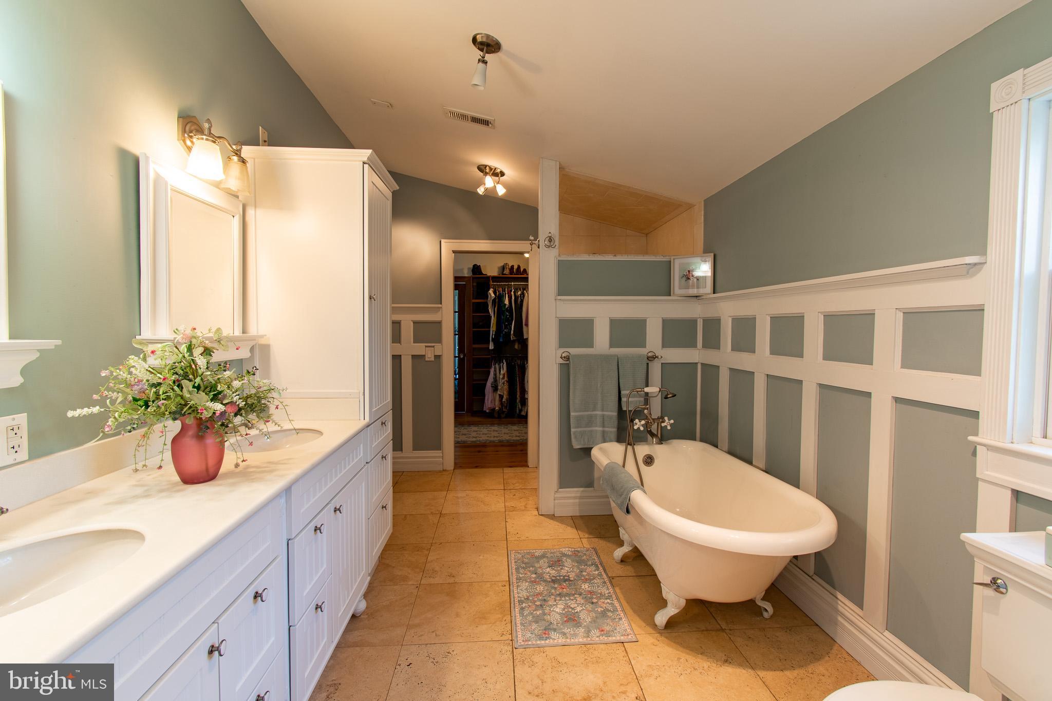 114 West Chestnut Street St. Michaels, MD 21663 - Photo 24 of 75 a spacious bathroom with a granite countertop sink toilet and shower
