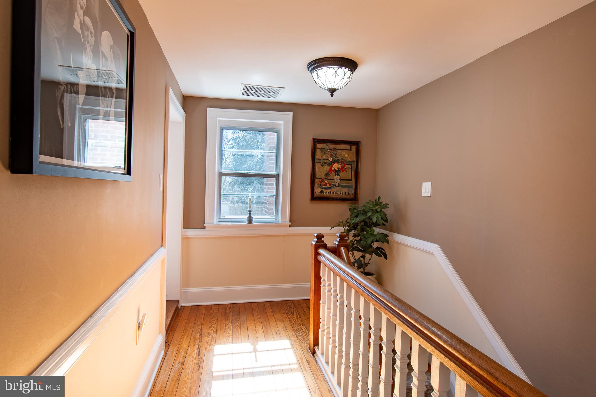 114 West Chestnut Street St. Michaels, MD 21663 - Photo 25 of 75 a view of hallway with wooden floor and stairs