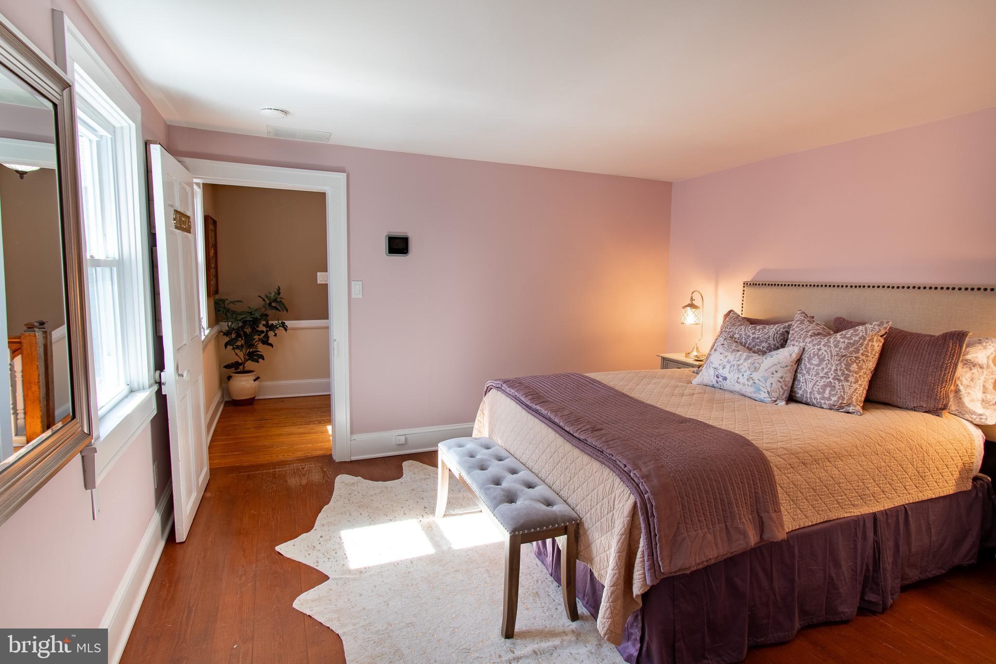 114 West Chestnut Street St. Michaels, MD 21663 - Photo 27 of 75 a bedroom with a bed and wooden floor