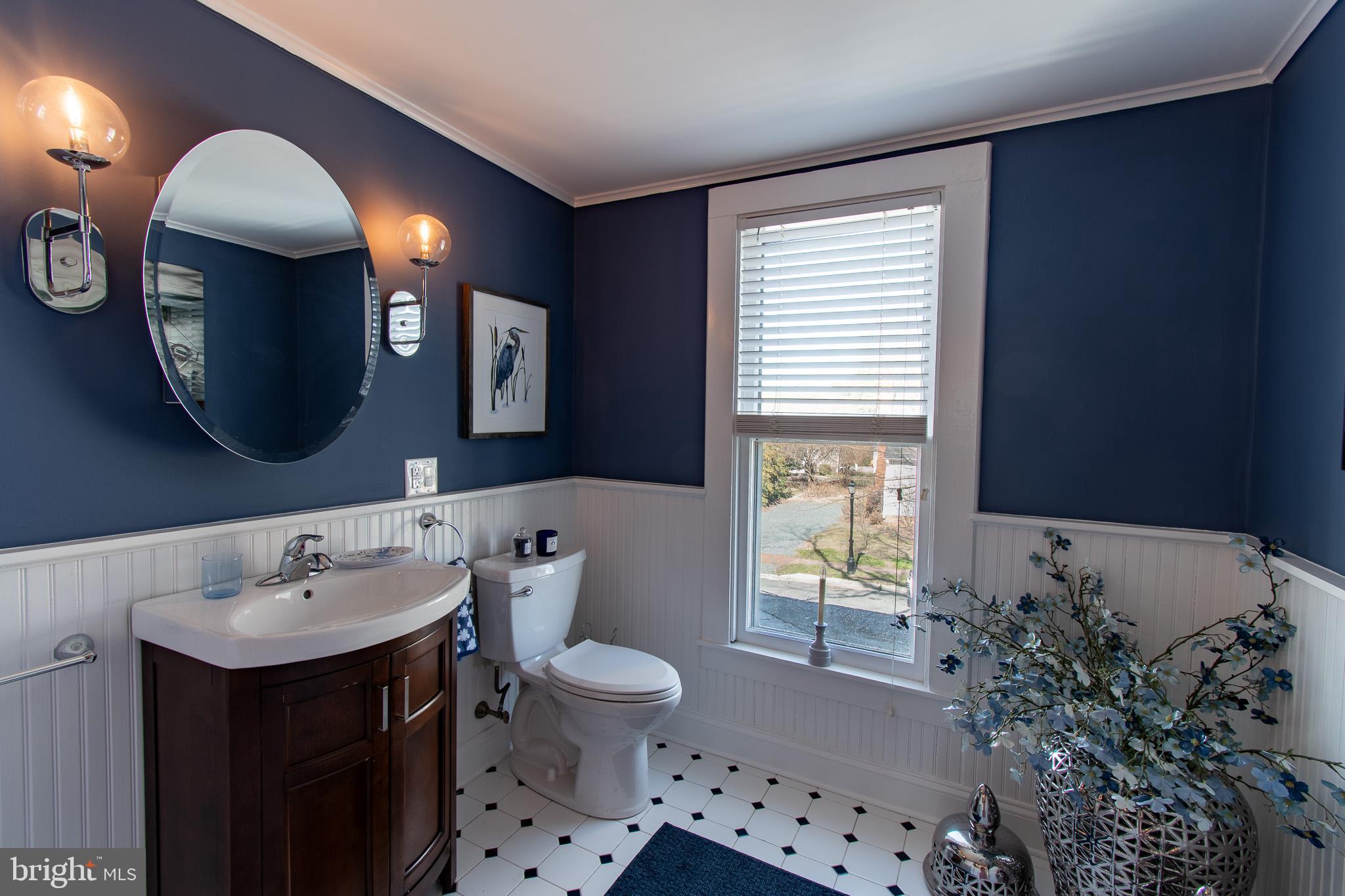 114 West Chestnut Street St. Michaels, MD 21663 - Photo 29 of 75 a bathroom with a sink and a mirror