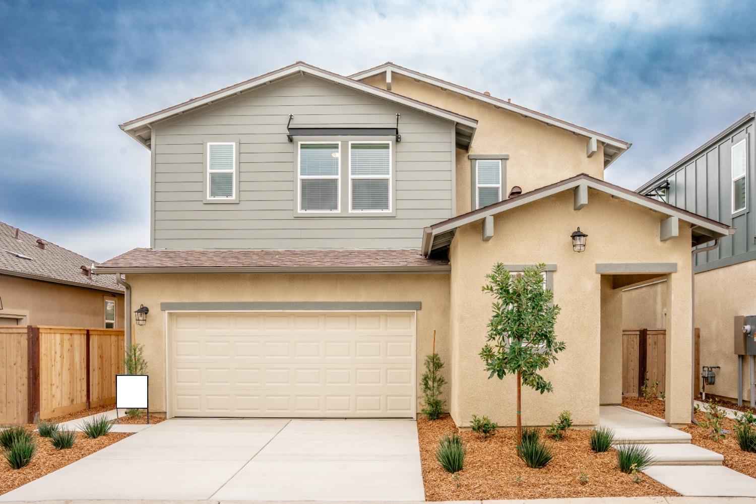 696 Philip Way Madera, CA 93636 - Photo 2 of 23 a front view of a house with a yard and garage