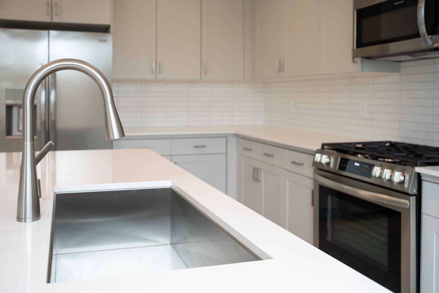 696 Philip Way Madera, CA 93636 - Photo 4 of 23 a kitchen with a sink and a stove top oven