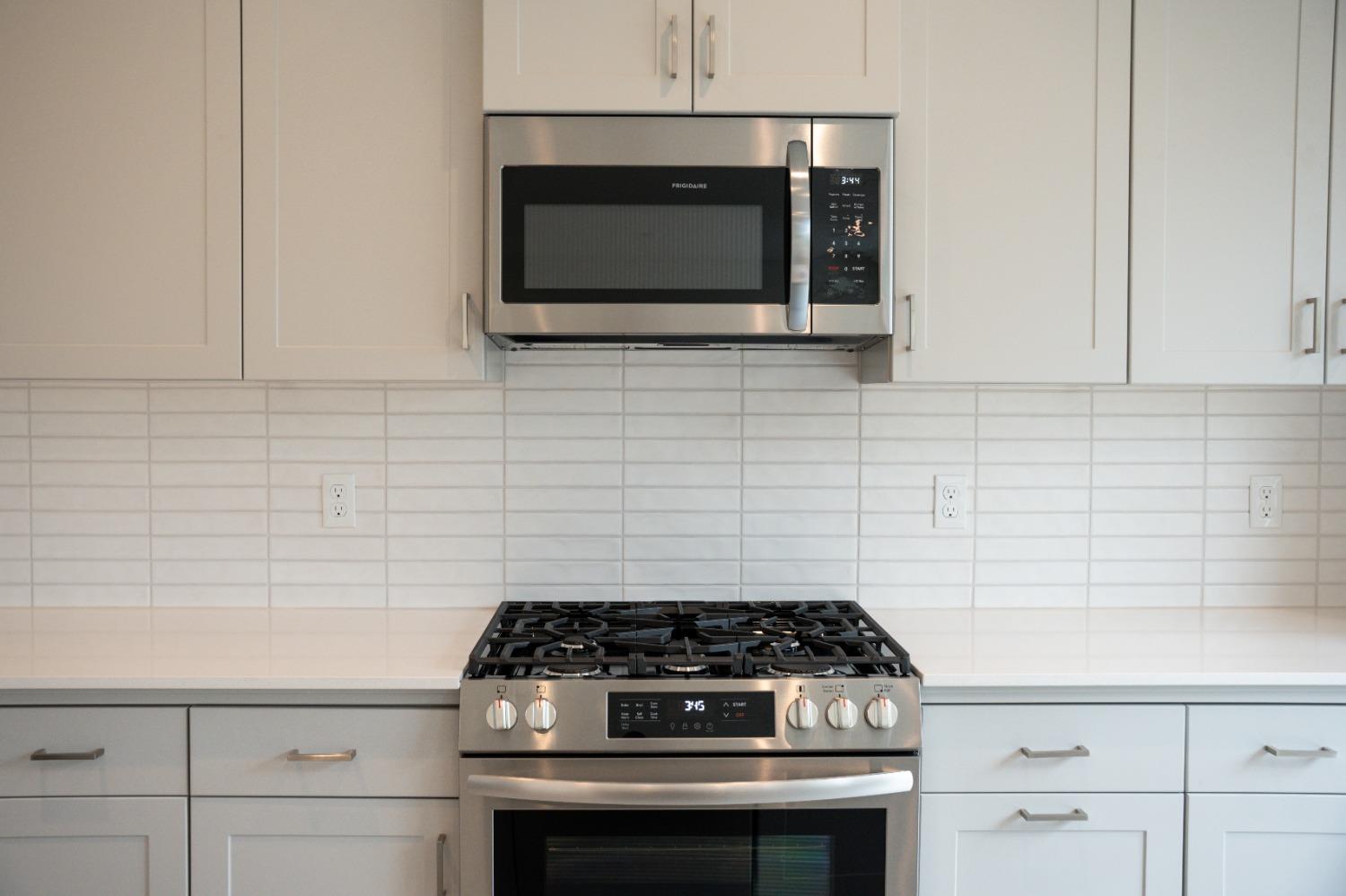 696 Philip Way Madera, CA 93636 - Photo 5 of 23 a stove top oven sitting inside of a kitchen