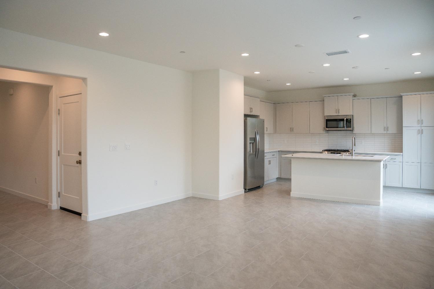 696 Philip Way Madera, CA 93636 - Photo 6 of 23 a view of kitchen with kitchen island and stainless steel appliances