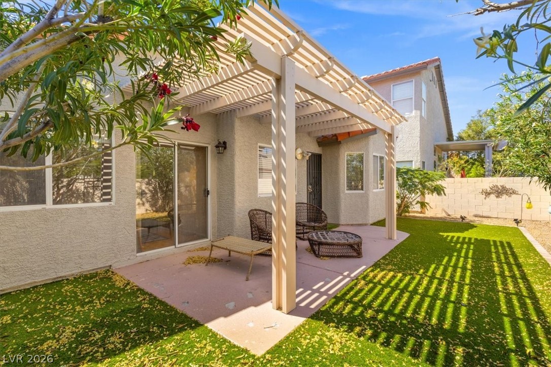 2377 Ramsgate Drive Henderson, NV 89074 - Photo 3 of 25 Relax and unwind under the shade of a charming patio pergola, overlooking a low-maintenance backyard.