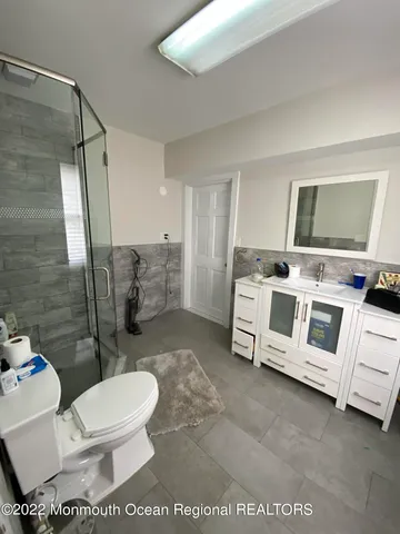 a white toilet sitting next to a bathroom sink