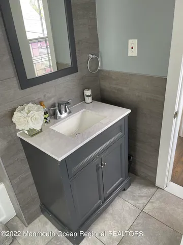 a bathroom with a sink vanity and a mirror