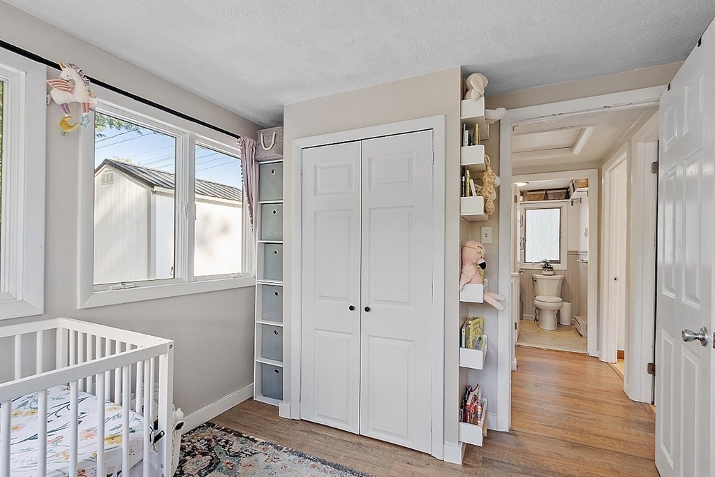 98 Boat House Road Groton, MA 01450 - Photo 27 of 39 a view of a hallway with wooden floor and closet area