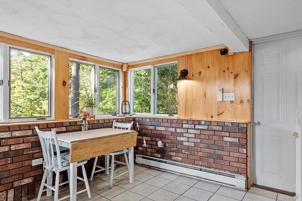 98 Boat House Road Groton, MA 01450 - Photo 30 of 39 a view of a dining room with furniture large windows and wooden floor