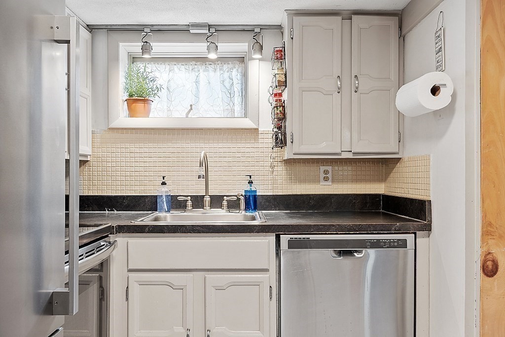 98 Boat House Road Groton, MA 01450 - Photo 36 of 39 a kitchen with stainless steel appliances granite countertop a sink and a white cabinets