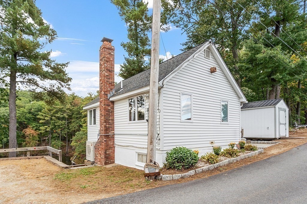 98 Boat House Road Groton, MA 01450 - Photo 39 of 39 a view of a white house with a small yard and large tree