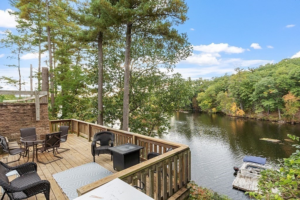 98 Boat House Road Groton, MA 01450 - Photo 7 of 39 a view of a chairs and table on the terrace