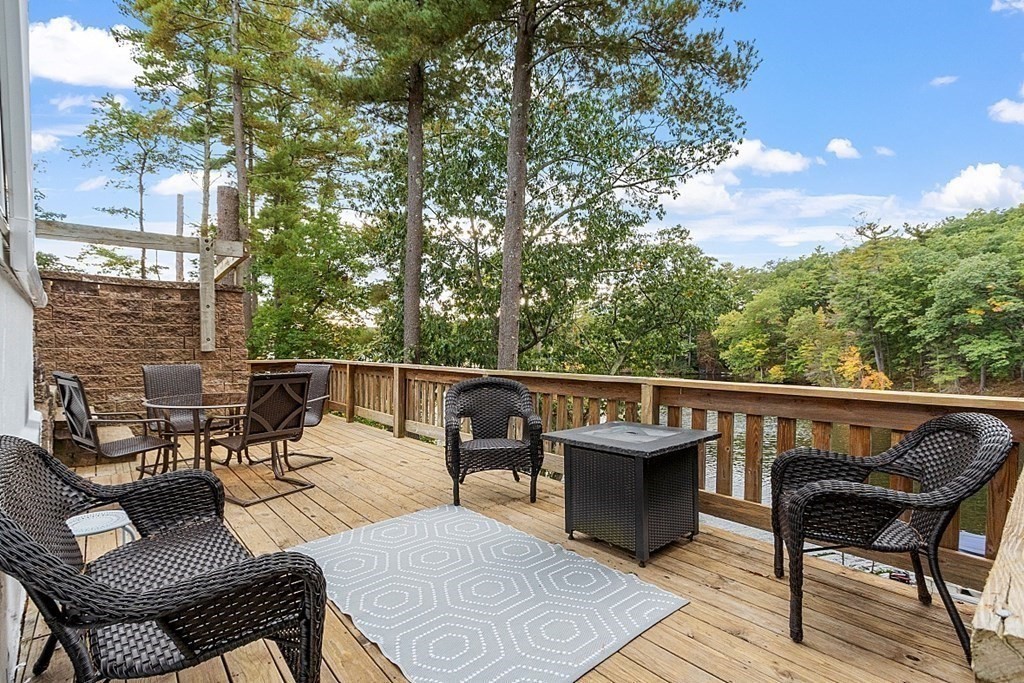 98 Boat House Road Groton, MA 01450 - Photo 8 of 39 a view of a patio with table and chairs and couches