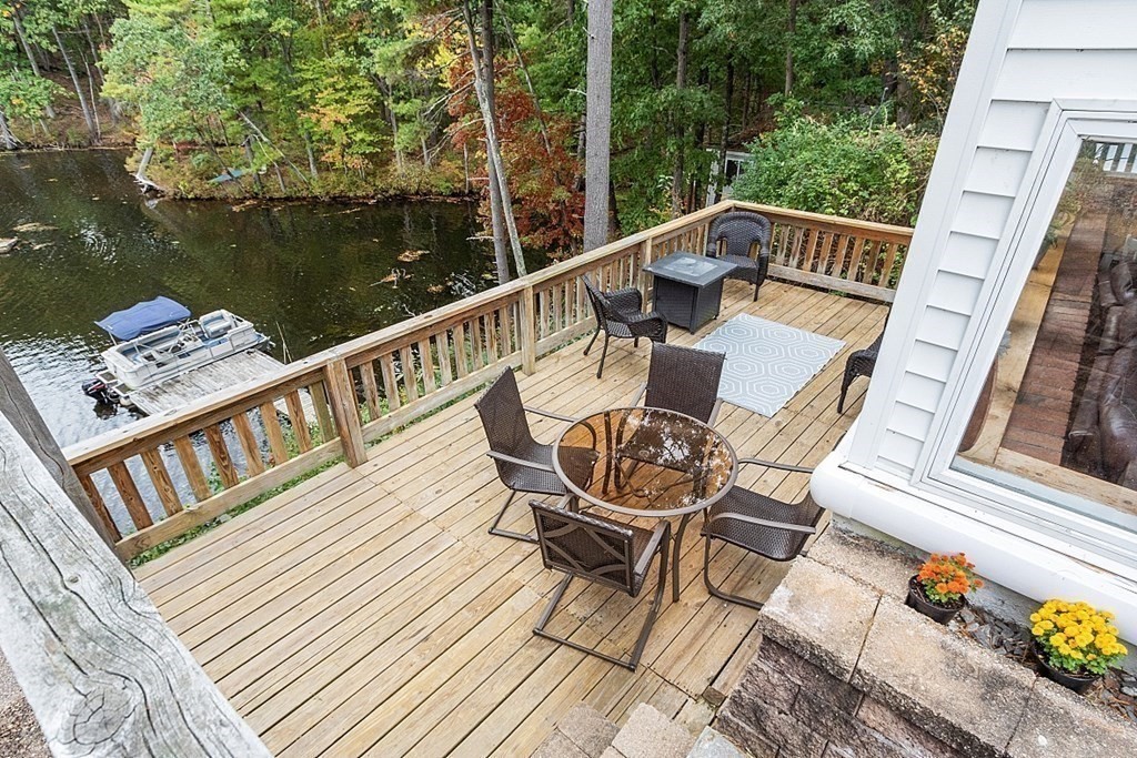 98 Boat House Road Groton, MA 01450 - Photo 10 of 39 a view of a balcony with wooden floor and outdoor seating