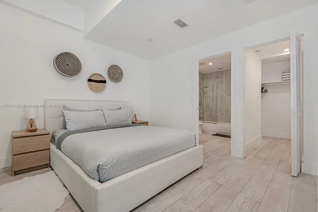 a large white bed in a white room