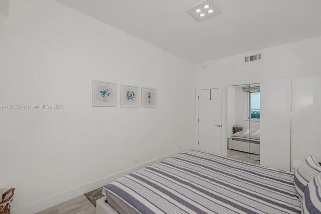 a view of a bedroom with wooden floor and bedroom