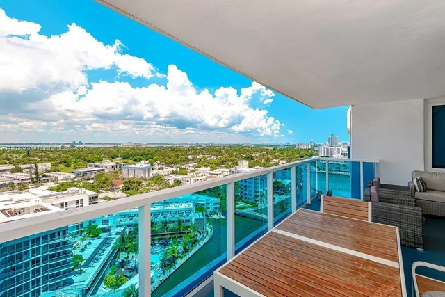 a view of a balcony with wooden floor and city view