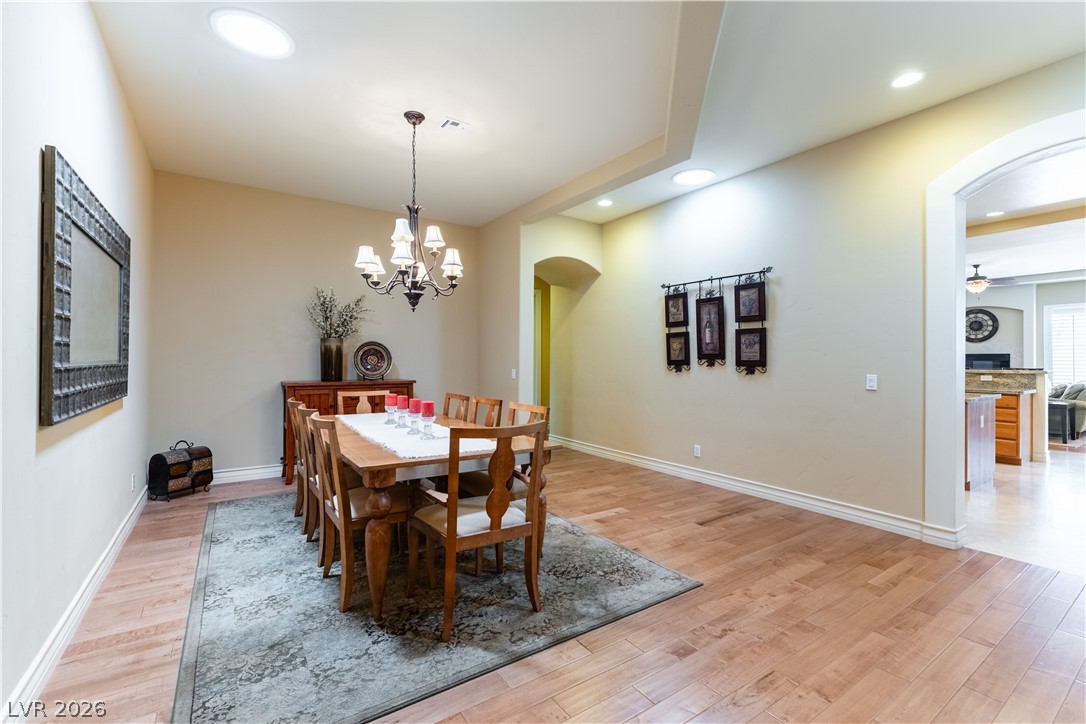 3661 Riley Ann Avenue Las Vegas, NV 89139 - Photo 6 of 42 Hardwood floors and tray ceilings define this inviting dining area, ideal for memorable gatherings.