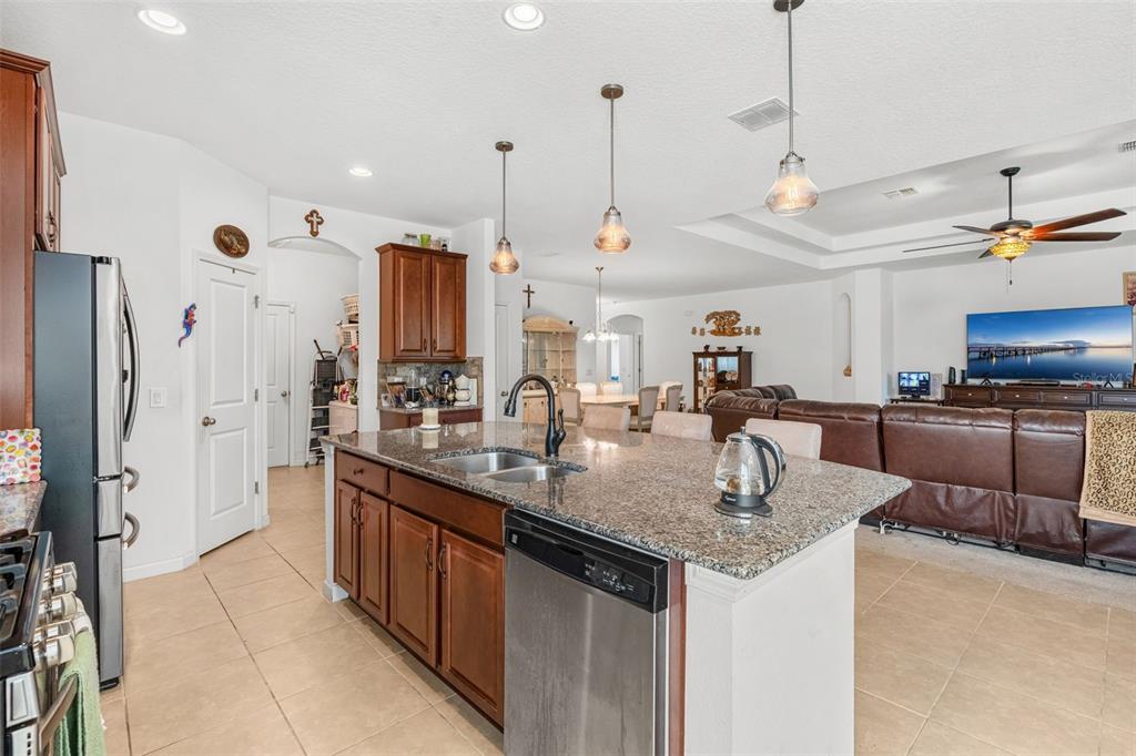 2085 Lula Road Minneola, FL 34715 - Photo 19 of 39 a kitchen with stainless steel appliances granite countertop a sink and a refrigerator