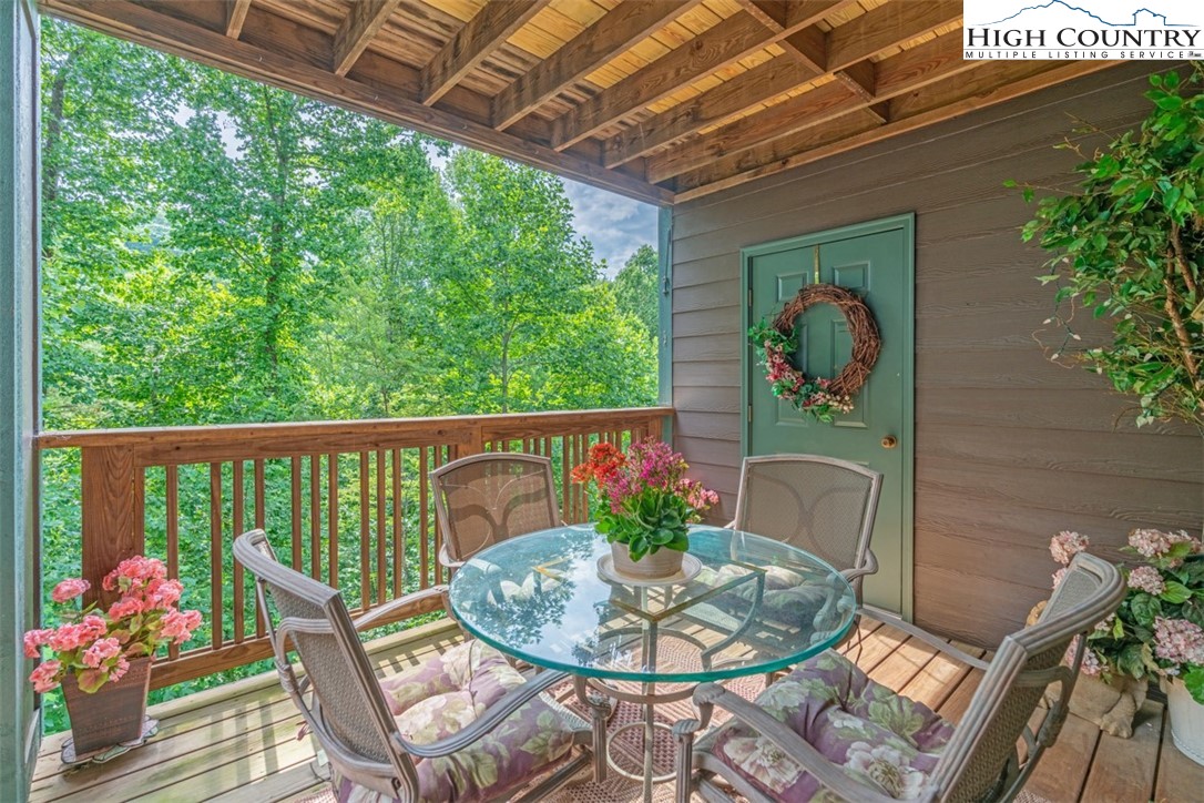a balcony with furniture and flowers