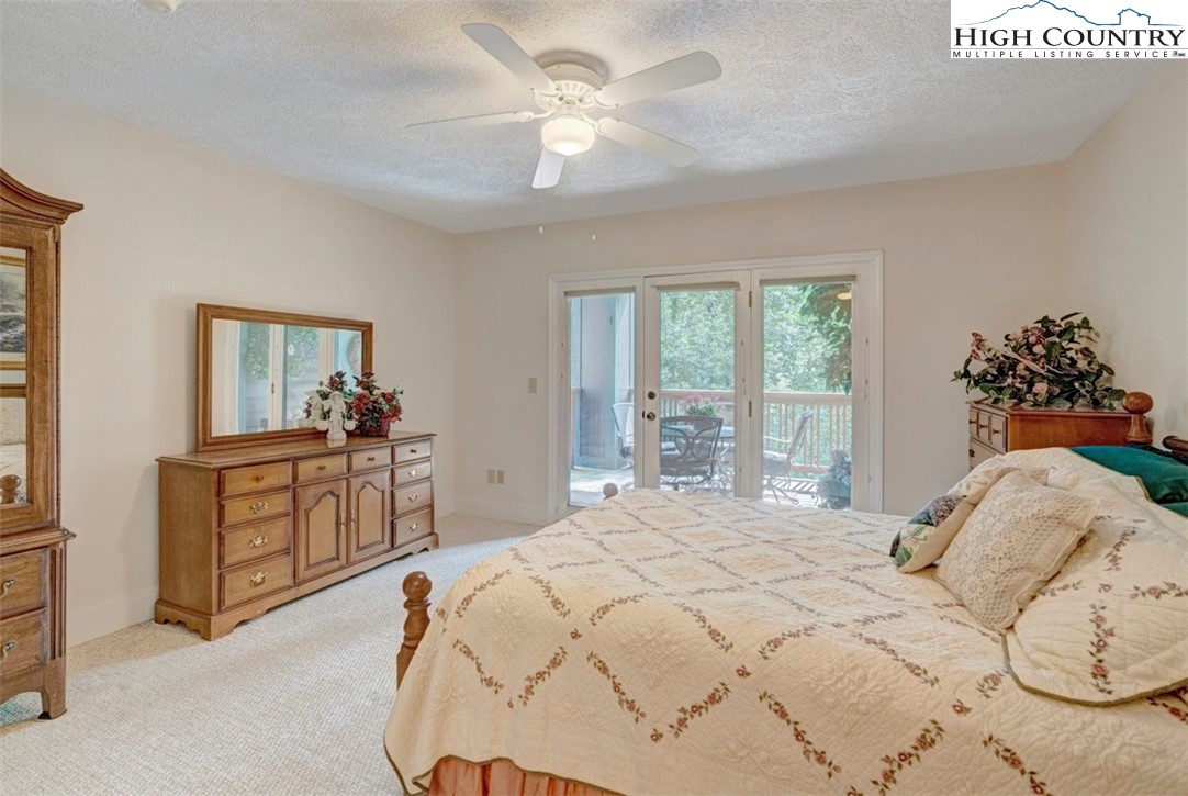 190 Still Lake Drive, Unit 321 Boone, NC 28607 - Photo 14 of 30 a bedroom with a large bed and a chandelier